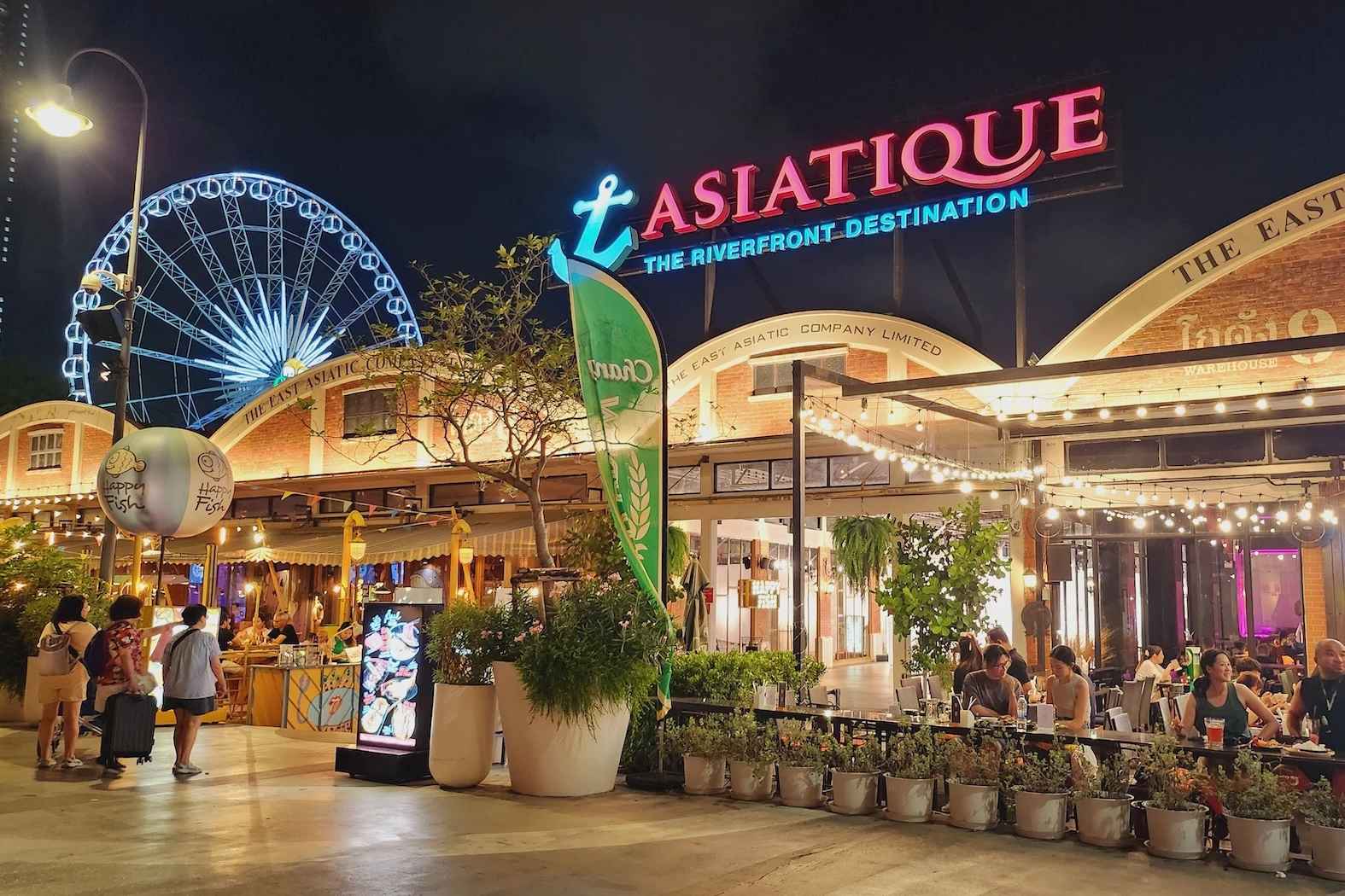 Exterior of Asiatique The Riverfront place with giant ferris wheel by night near Chao Phraya in Bangkok