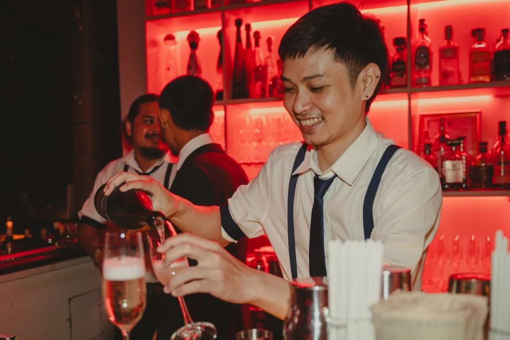 bartender pouring Champagne for guests at Pastel Bangkok