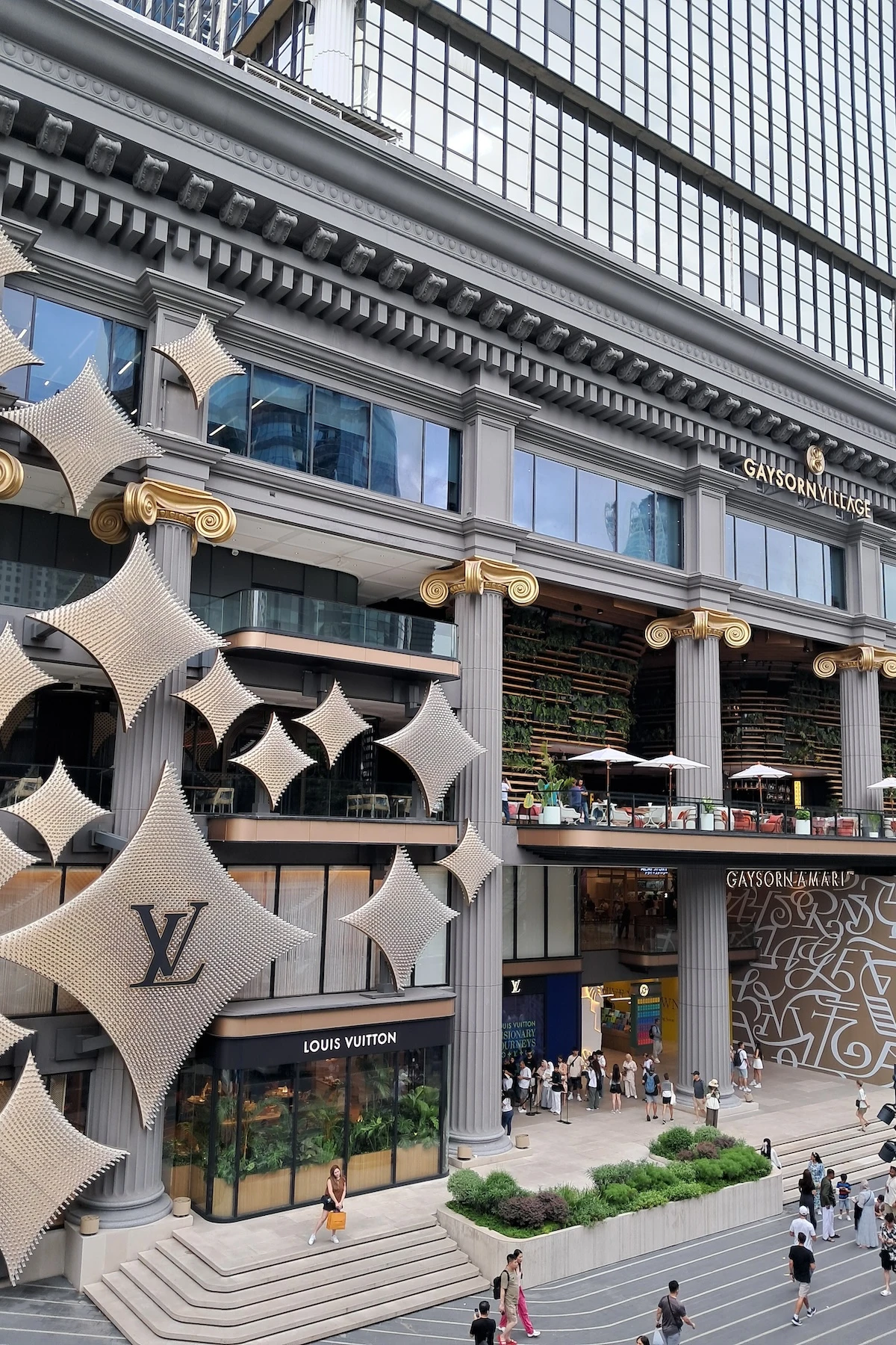 Exterior of Gaysorn Village with a view of the facade of Louis Vuitton Café near the BTS Chit Lom in Bangkok