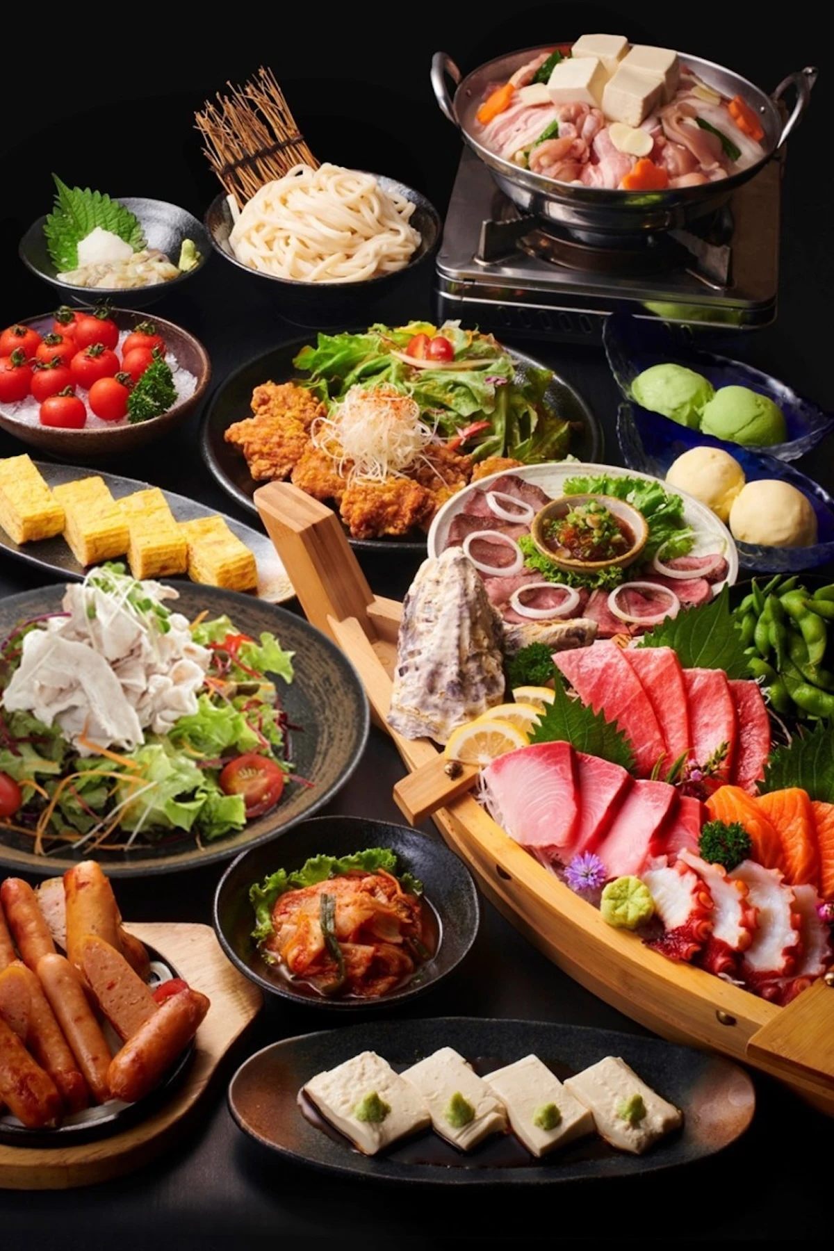 An assortment of Japanese dishes, including sashimi, noodles, fried chicken, and fresh vegetables, offering an authentic culinary experience at Shakariki 432 restaurant.